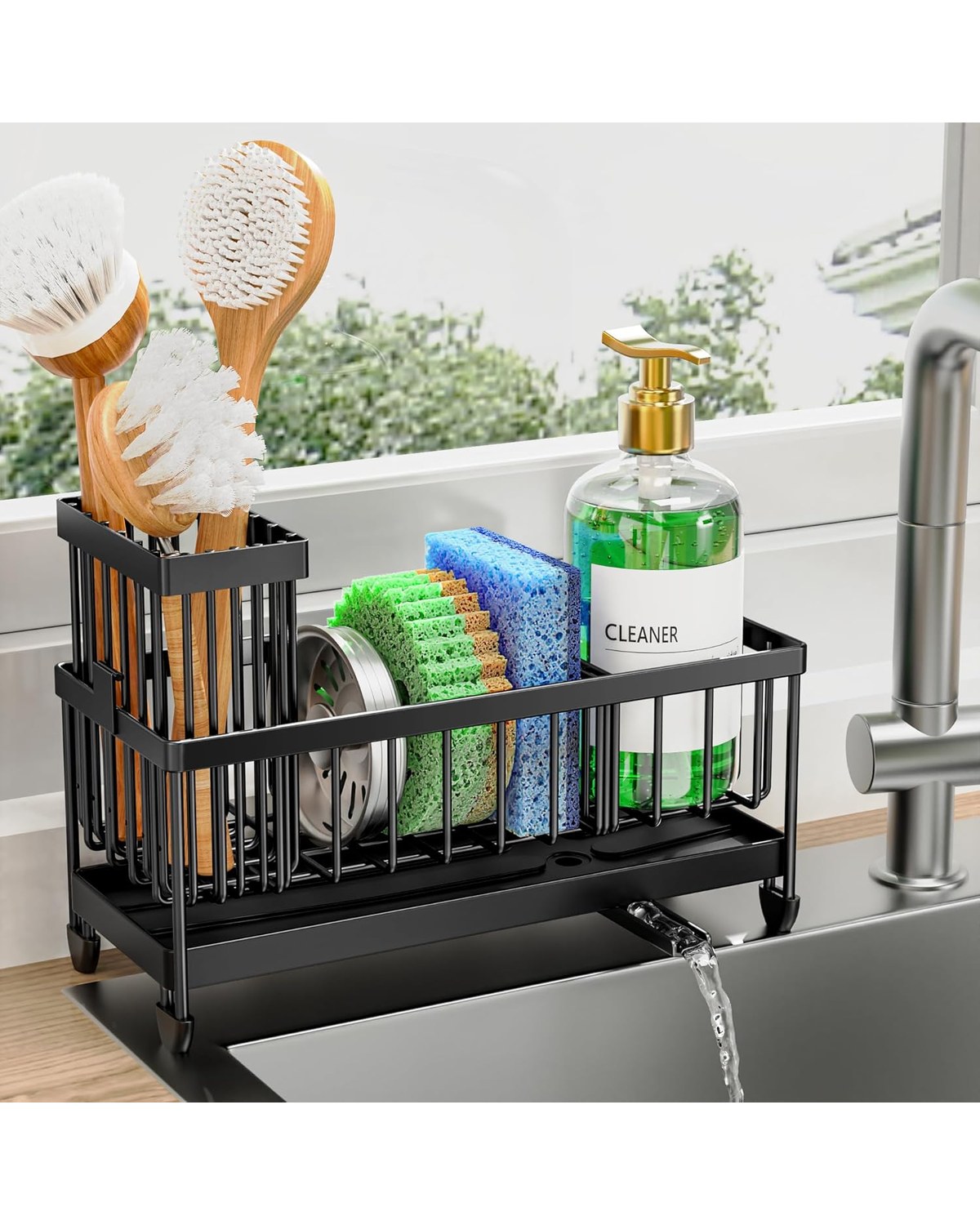 A sleek chrome-finish caddy mounted on a modern farmhouse sink backsplash, holding a sponge, dish brush, and soap dispenser in separate slots.